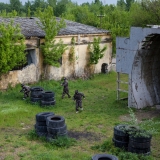 Takes place outdoor at an old stone mine - Paintball
